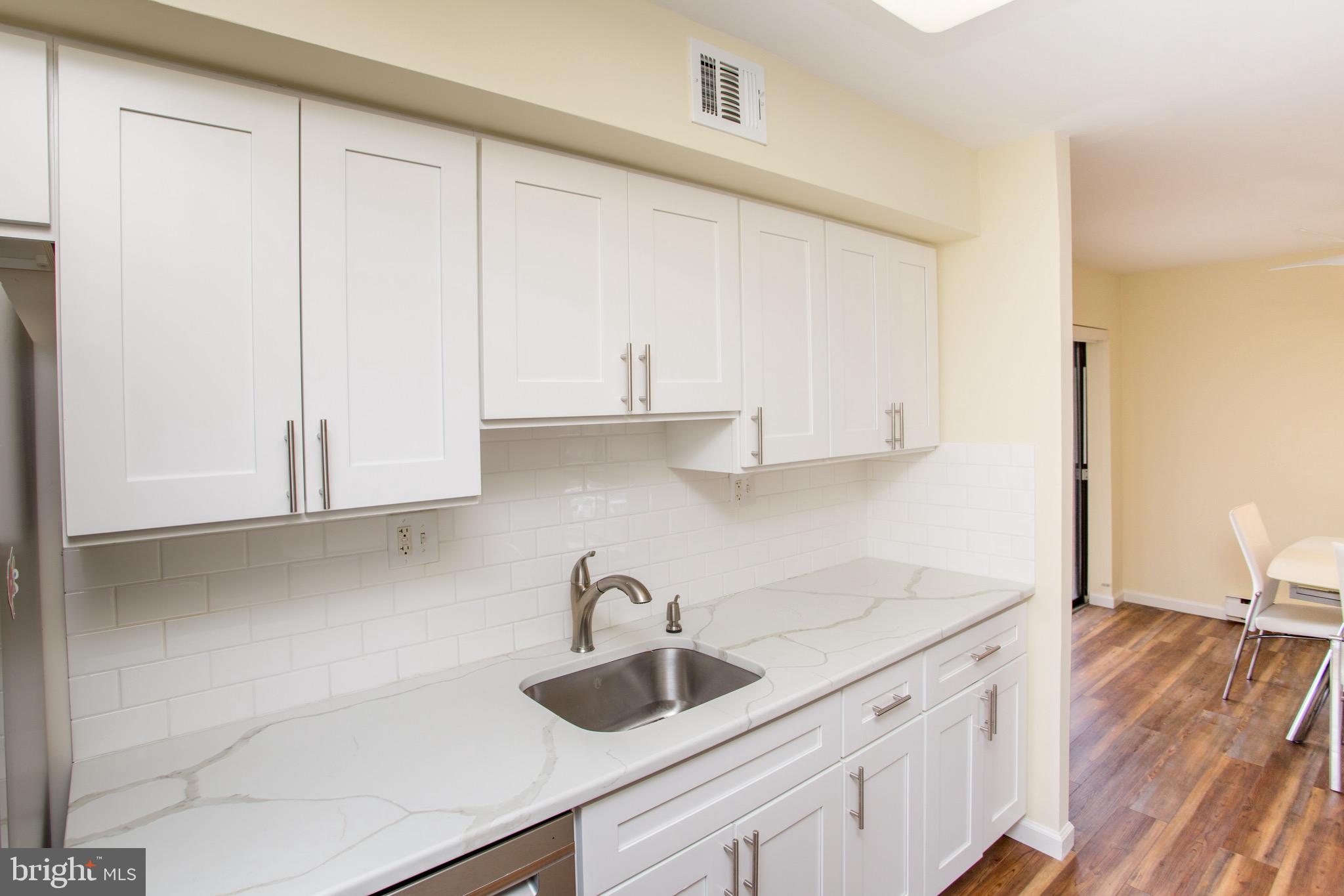 1680 Huntingdon Pike, Unit CONDO 224 Huntingdon Valley, PA 19006 - Photo 27 of 50 a kitchen with granite countertop white cabinets and a sink