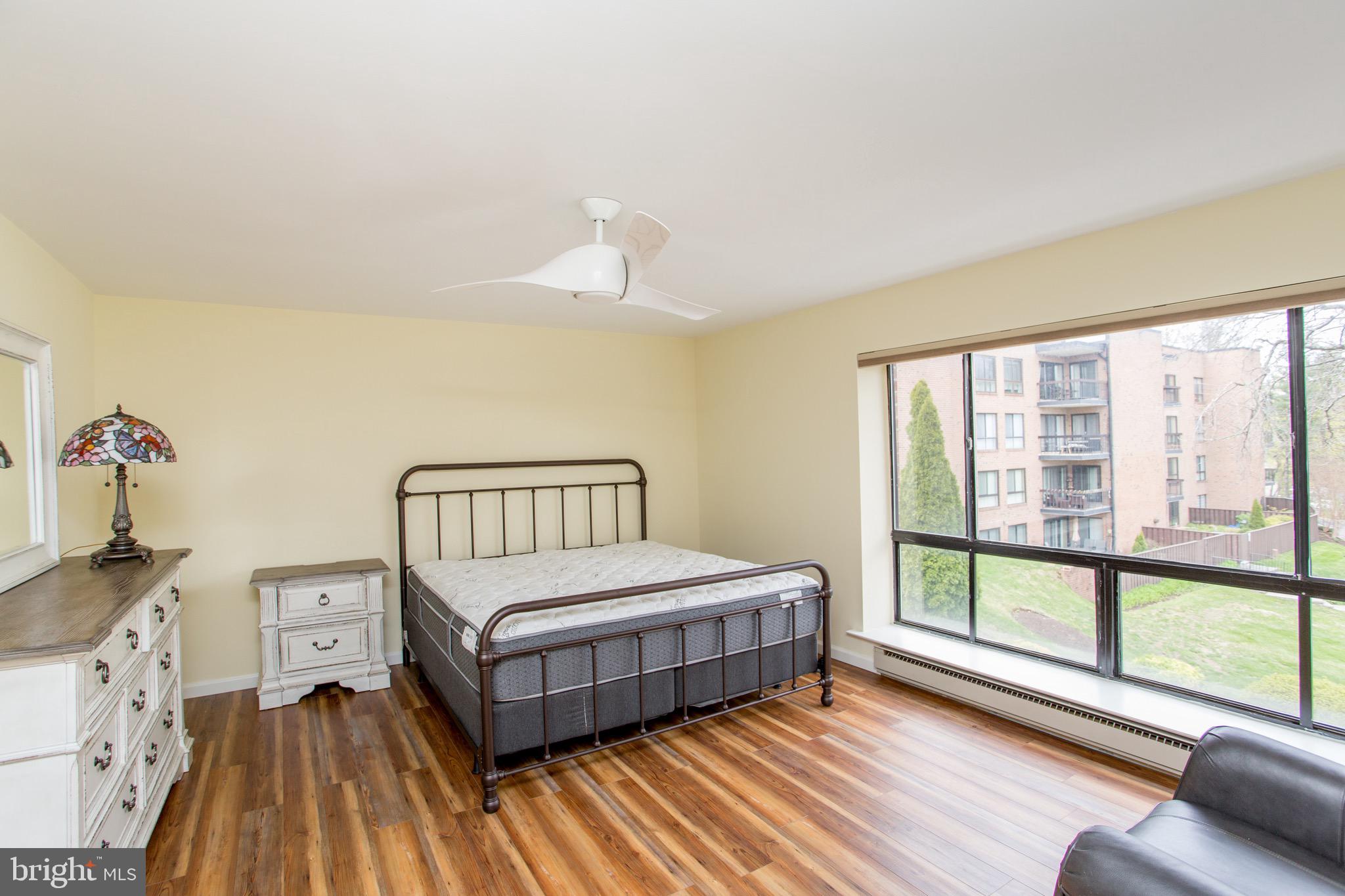 1680 Huntingdon Pike, Unit CONDO 224 Huntingdon Valley, PA 19006 - Photo 30 of 50 a spacious bedroom with a bed and a large window