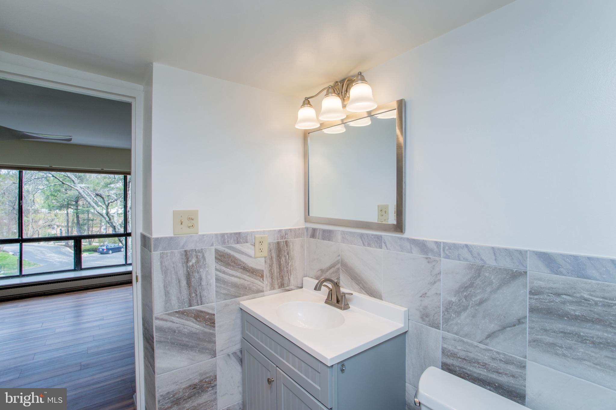 1680 Huntingdon Pike, Unit CONDO 224 Huntingdon Valley, PA 19006 - Photo 35 of 50 a bathroom with a sink vanity and a mirror