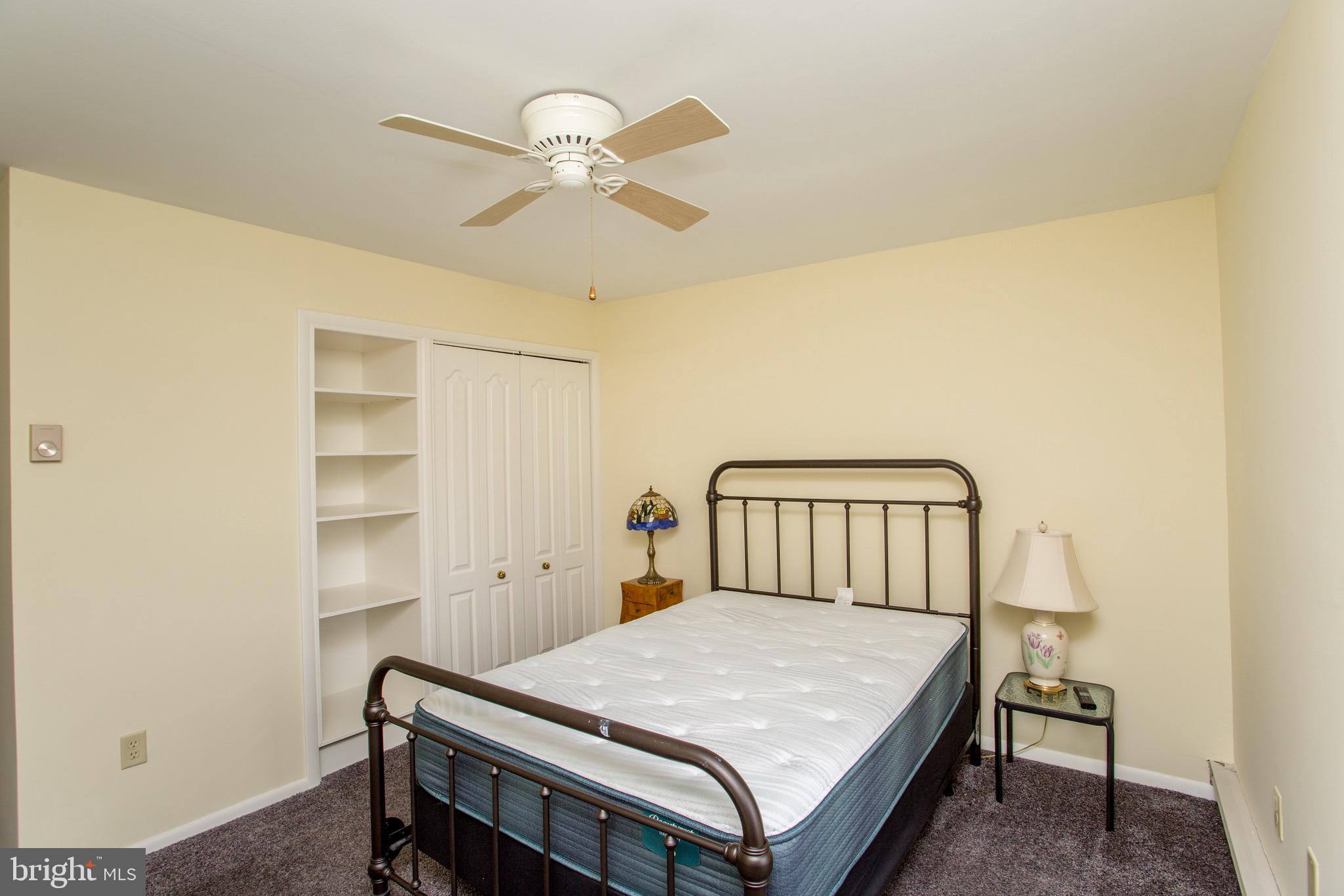 1680 Huntingdon Pike, Unit CONDO 224 Huntingdon Valley, PA 19006 - Photo 39 of 50 a bedroom with a bed and a chandelier