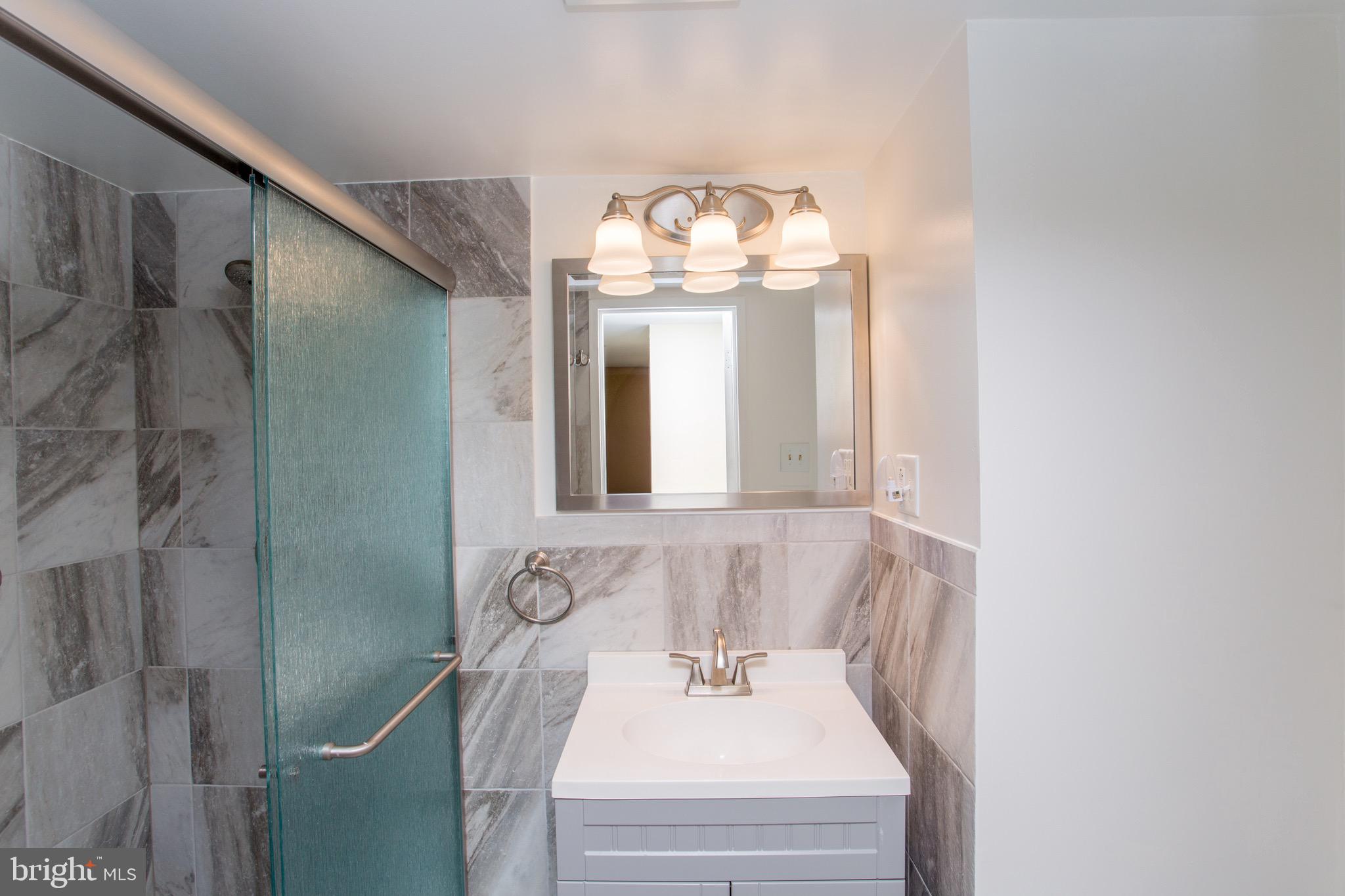 1680 Huntingdon Pike, Unit CONDO 224 Huntingdon Valley, PA 19006 - Photo 44 of 50 a bathroom with a sink and a mirror