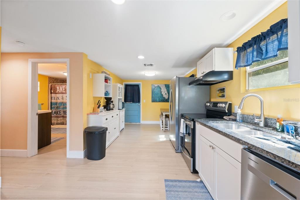 7965 West Riverbend Road Crystal River, FL 34428 - Photo 26 of 60 a large kitchen with stainless steel appliances granite countertop a sink and cabinets