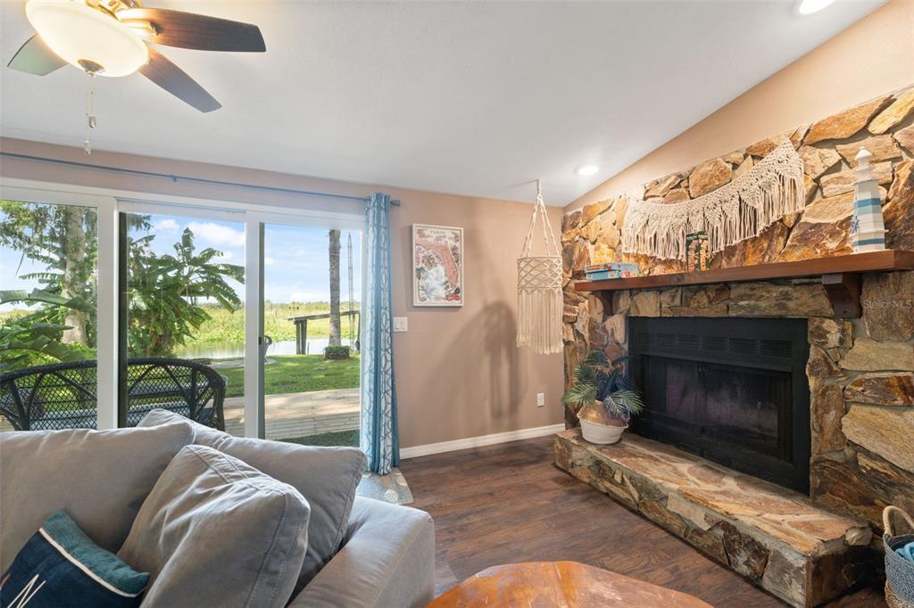 7965 West Riverbend Road Crystal River, FL 34428 - Photo 31 of 60 a living room with furniture a large window and a fireplace