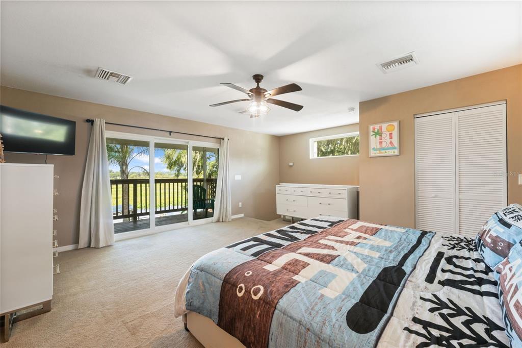 7965 West Riverbend Road Crystal River, FL 34428 - Photo 39 of 60 a bedroom with a large bed and a large window