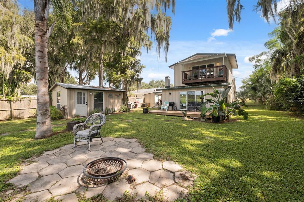 7965 West Riverbend Road Crystal River, FL 34428 - Photo 9 of 60 a view of a backyard with table and chairs with wooden fence and plants