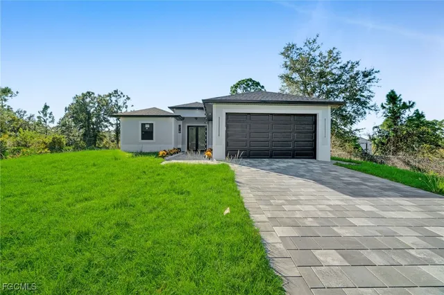 a front view of house with yard and green space