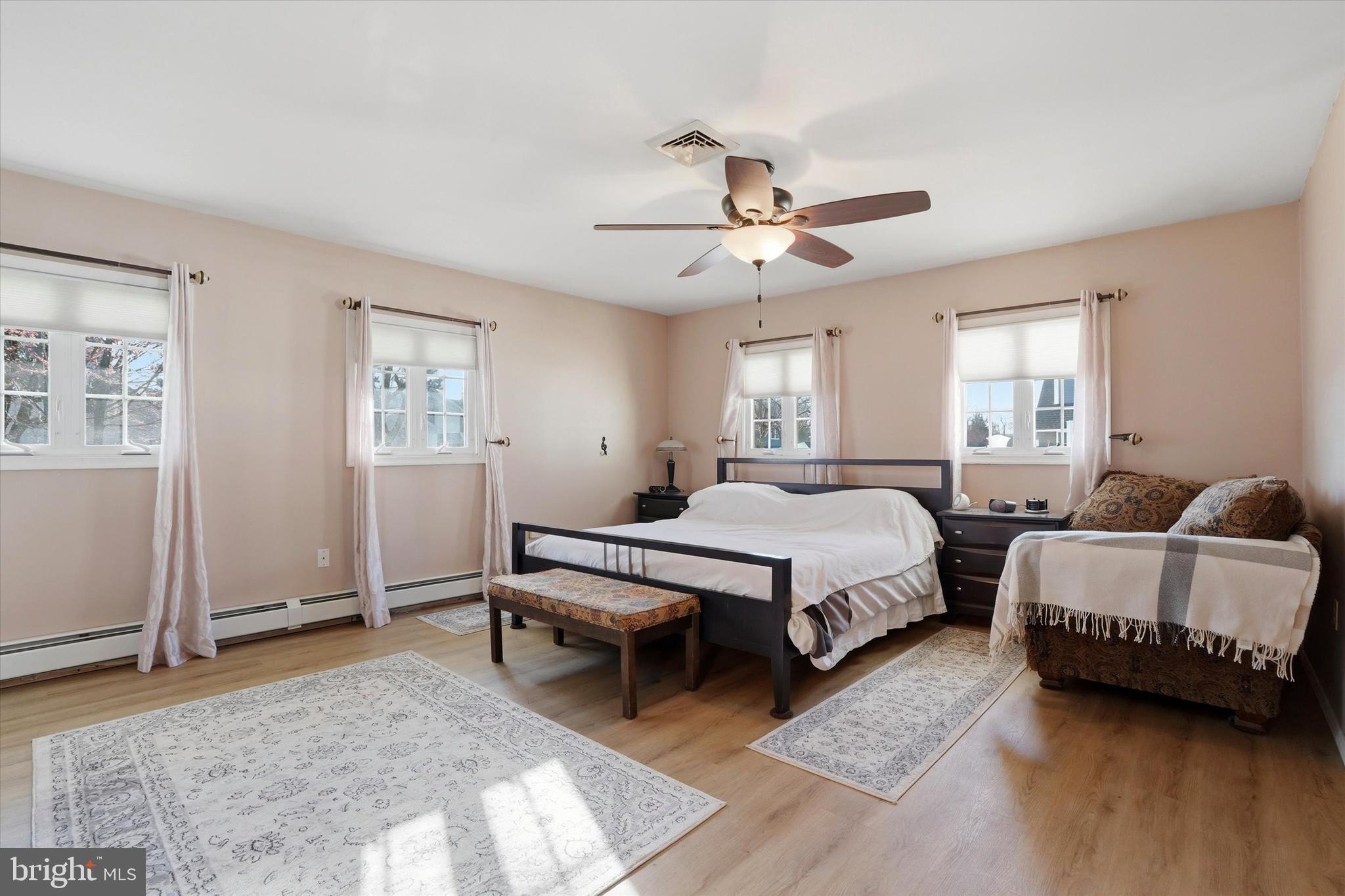 28 Sycamore Road Levittown, PA 19056 - Photo 11 of 31 a spacious bedroom with two beds a chandelier and a window
