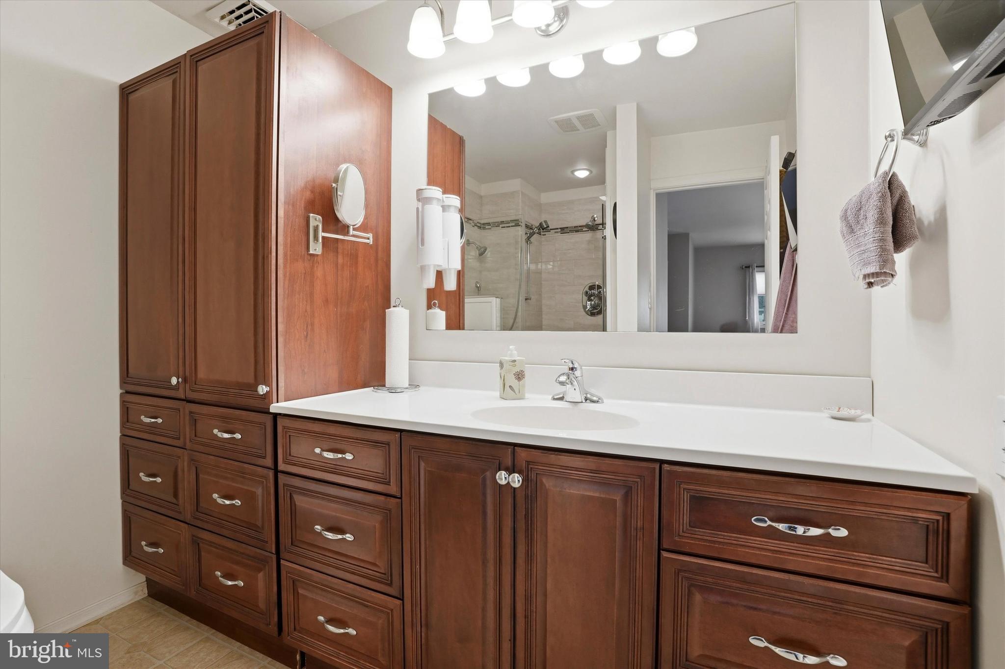 28 Sycamore Road Levittown, PA 19056 - Photo 13 of 31 a bathroom with a sink a vanity and a mirror