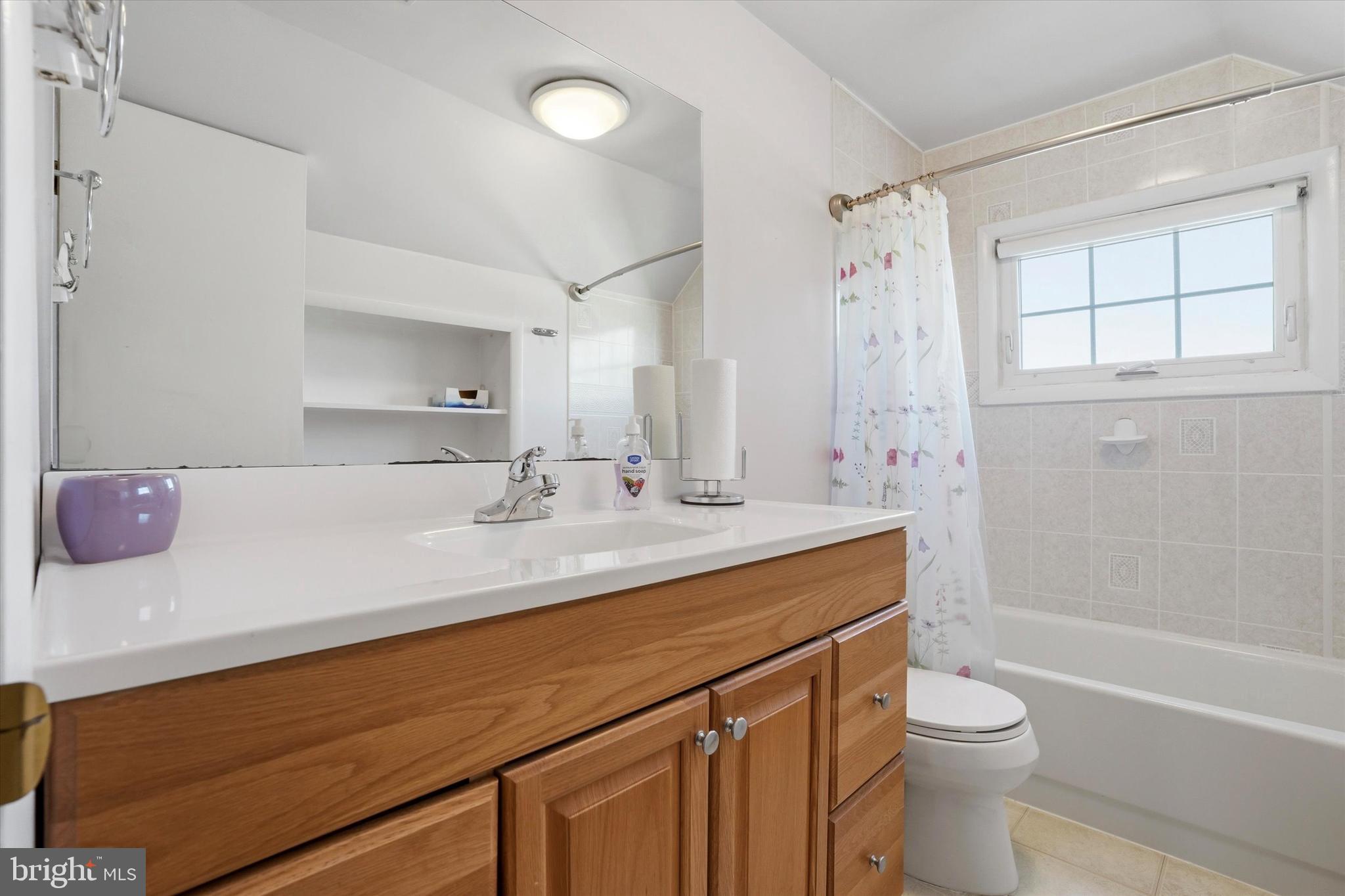 28 Sycamore Road Levittown, PA 19056 - Photo 23 of 31 a bathroom with a granite countertop sink a toilet a shower and a mirror