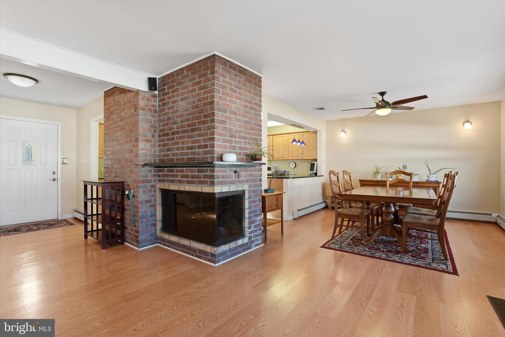 28 Sycamore Road Levittown, PA 19056 - Photo 6 of 31 a living room with furniture a fireplace and kitchen view