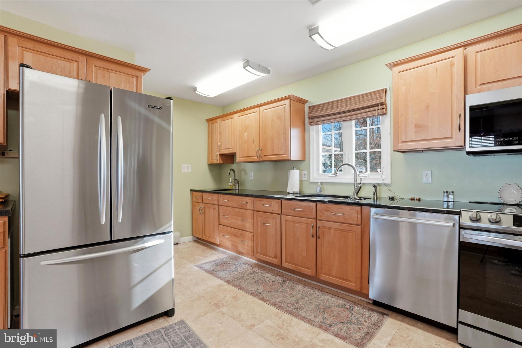 28 Sycamore Road Levittown, PA 19056 - Photo 9 of 31 a kitchen with stainless steel appliances granite countertop a refrigerator sink and microwave