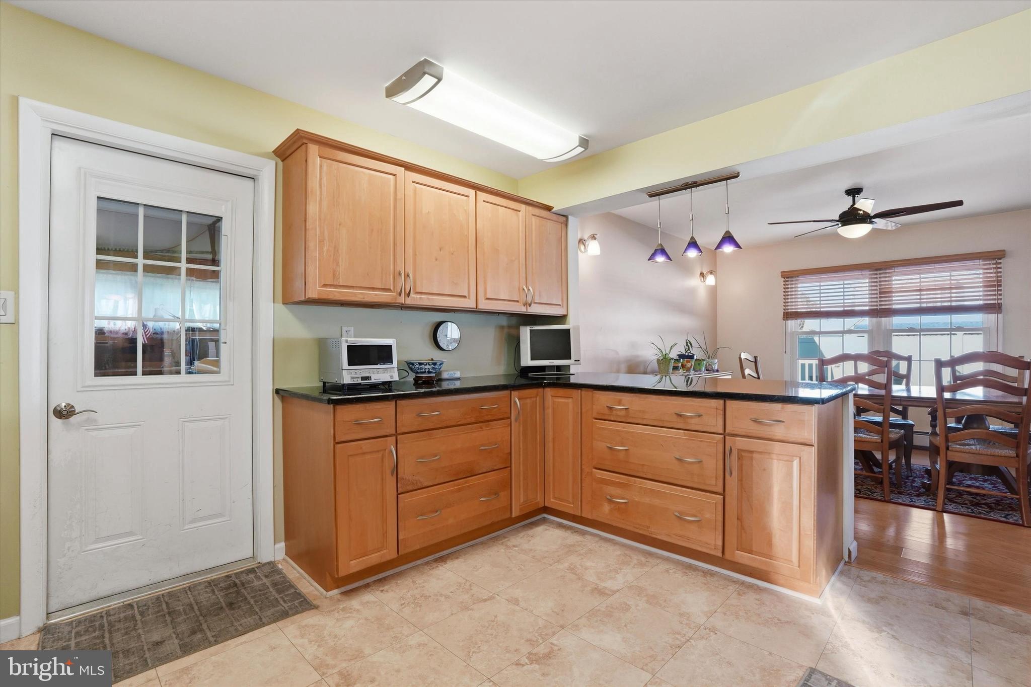28 Sycamore Road Levittown, PA 19056 - Photo 10 of 31 a kitchen with stainless steel appliances granite countertop a stove a sink and a refrigerator