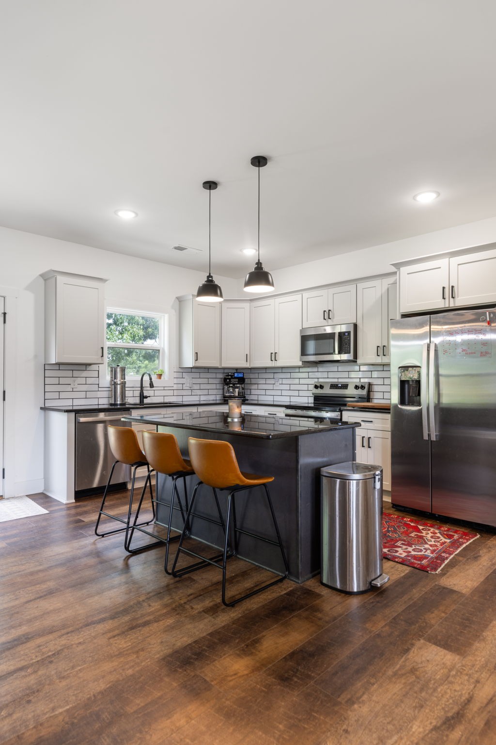 1578 Angus Way Greenbrier, TN 37073 - Photo 16 of 45 a kitchen with stainless steel appliances kitchen island granite countertop a table chairs sink and cabinets