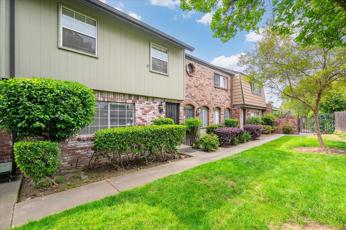 10919 Coloma Road, Unit 2 Rancho Cordova, CA 95670 - Photo 2 of 34 Grassy area in front of unit that shares a fence with the neighboring Sun River development.