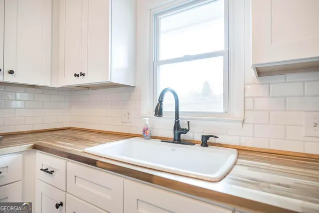 a bathroom with a sink and a window