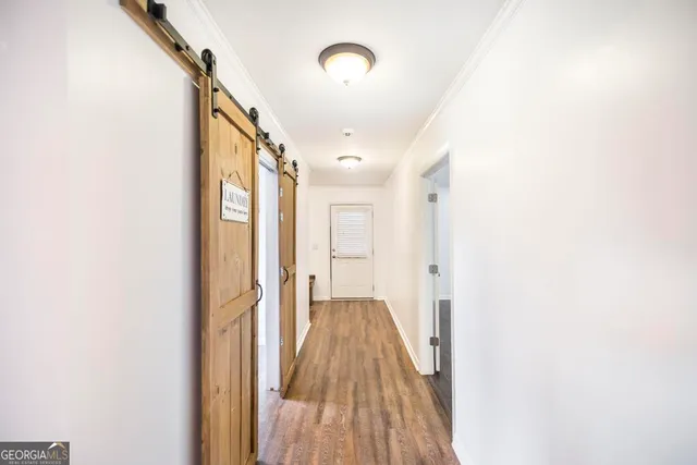 a view of a hallway with wooden floor