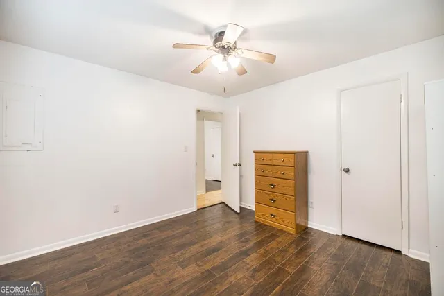 an empty room with closet and wooden floor