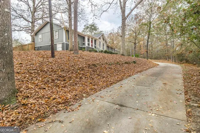 a front view of a house with a yard covered with snow