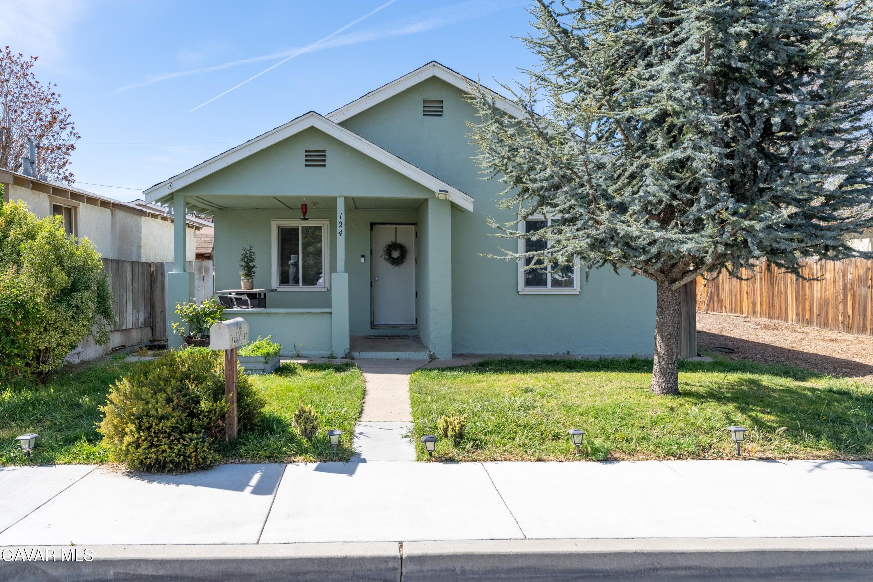 124 I Street East Tehachapi, CA 93561 - Photo 1 of 15 a front view of a house with garden
