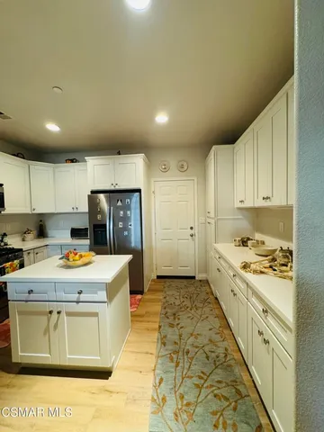 a kitchen with a stove a refrigerator and a sink