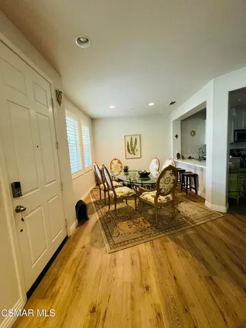 a living room with furniture a flat screen tv and a table