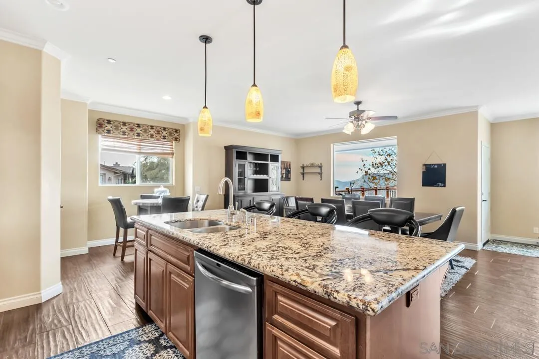 352 Sneath Way Alpine, CA 91901 - Photo 16 of 50 a dining table with chairs and kitchen view