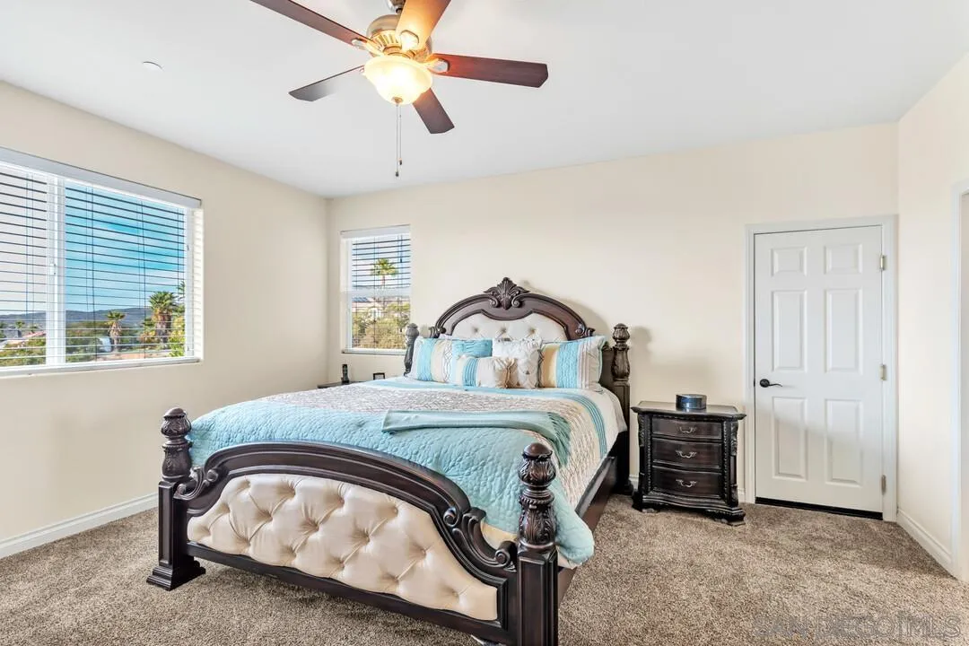 352 Sneath Way Alpine, CA 91901 - Photo 23 of 50 a bedroom with a bed and a chandelier
