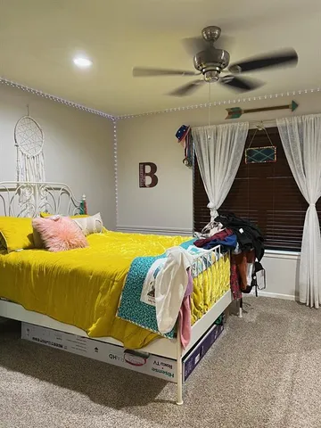 a bedroom with a bed and window