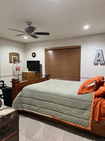 a bedroom with a bed and a chandelier