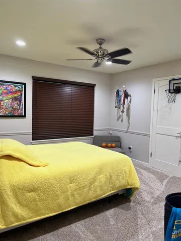 a bedroom with a bed and ceiling fan