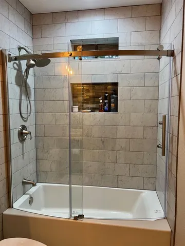 a bathroom with a shower and a bathtub