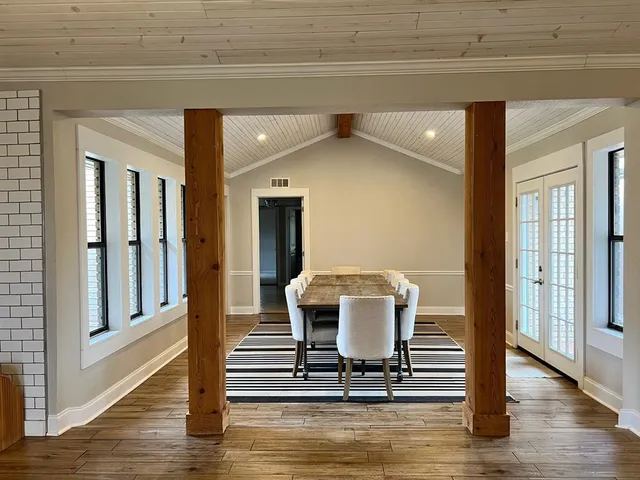 a view of a dining room with a table and chairs