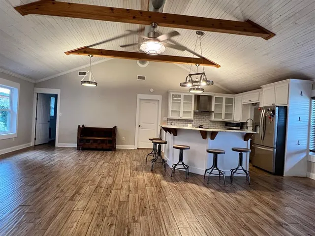 a view of a dining room with furniture and wooden floor
