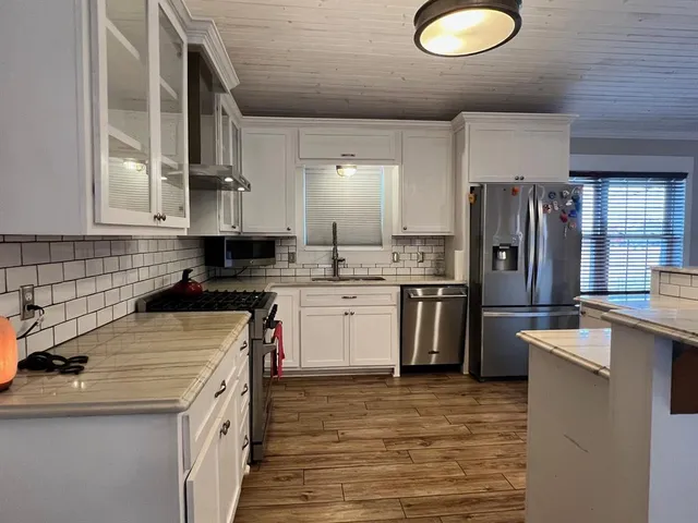 a kitchen with a stove a sink and a refrigerator