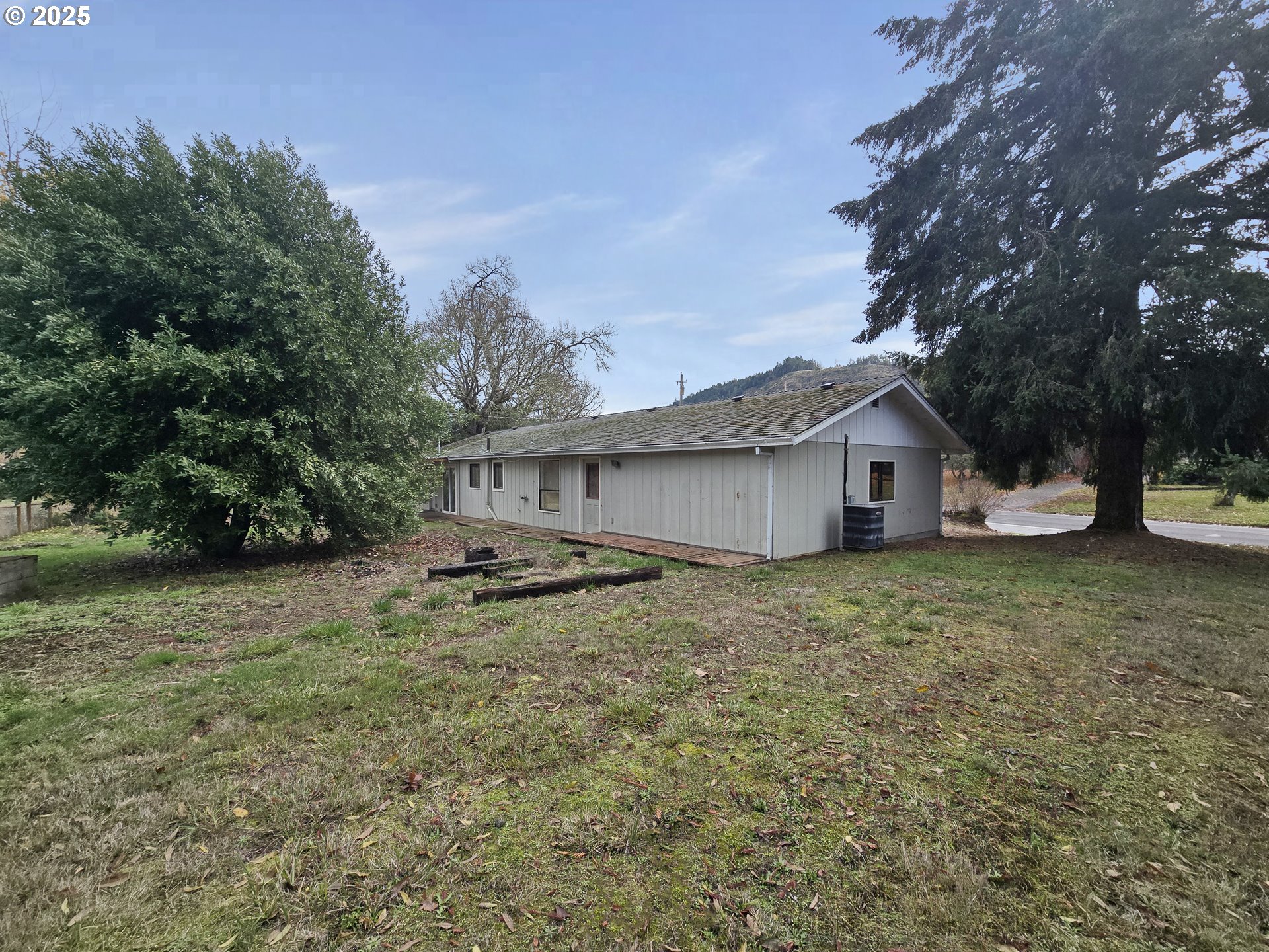 3249 Melrose Road Roseburg, OR 97471 - Photo 3 of 5 a view of a house with yard and sitting area