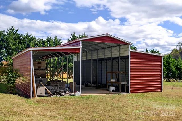 a view of a barn in the middle of a yard