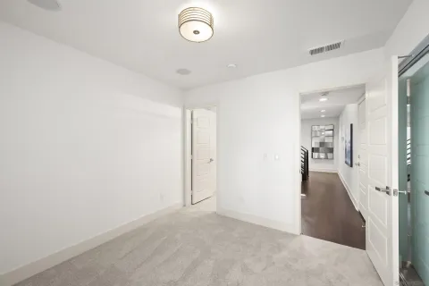 a view of a hallway with wooden floor and furniture