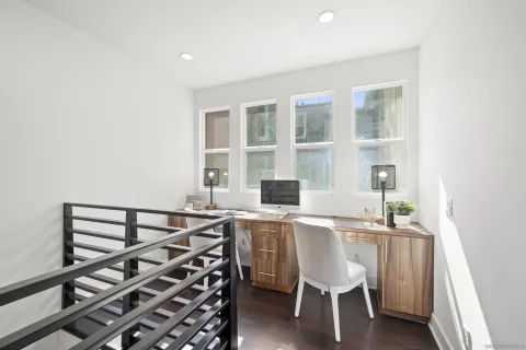 a dining room with furniture a large window and wooden floor