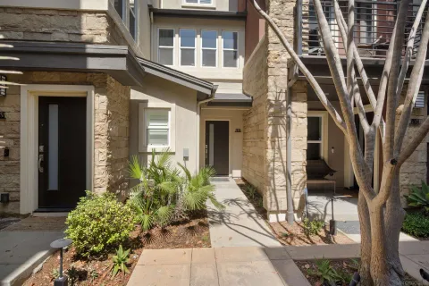 a kitchen with stainless steel appliances a sink a stove a refrigerator cabinets and a center island