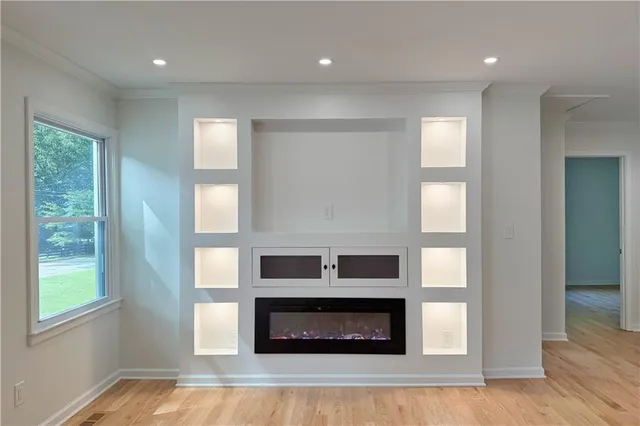 a living room with fireplace and wooden floor