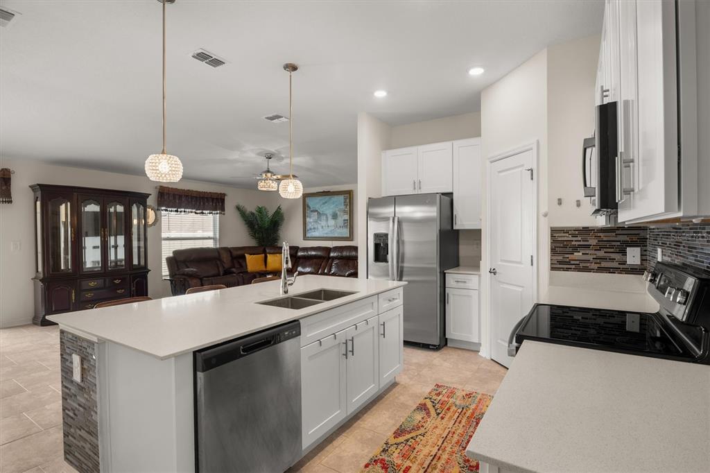287 Inman Boulevard Winter Haven, FL 33881 - Photo 12 of 36 a kitchen with a sink stainless steel appliances a counter top space