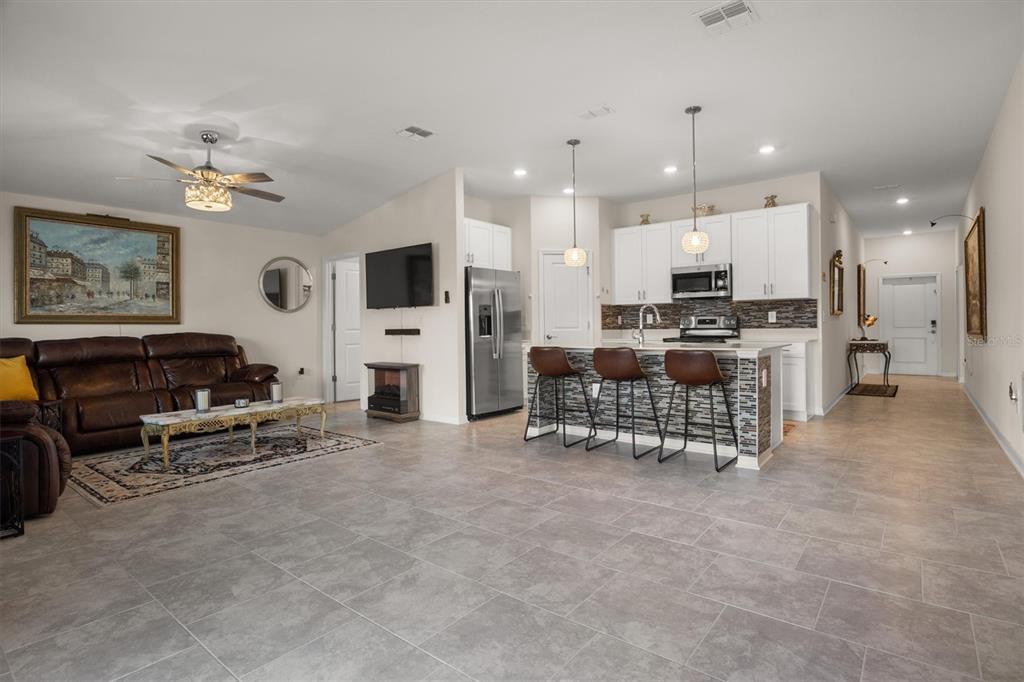 287 Inman Boulevard Winter Haven, FL 33881 - Photo 15 of 36 a living room with furniture a fireplace and a flat screen tv