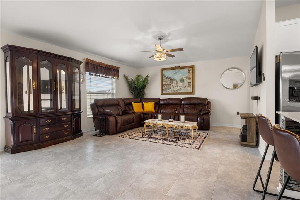 287 Inman Boulevard Winter Haven, FL 33881 - Photo 16 of 36 a living room with furniture a ceiling fan and a window