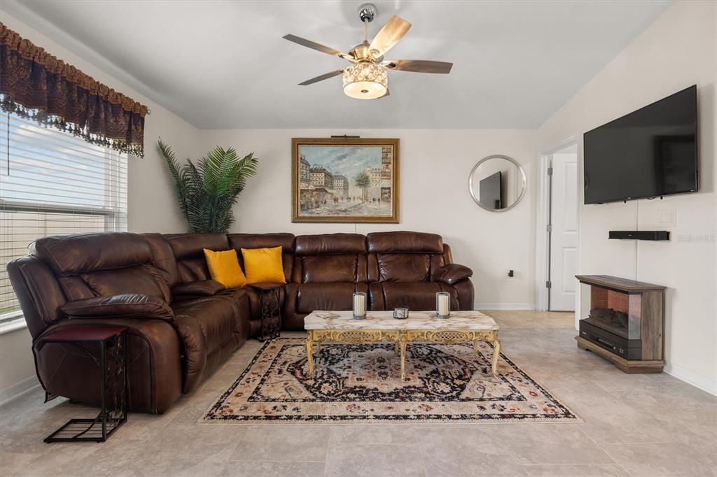 287 Inman Boulevard Winter Haven, FL 33881 - Photo 17 of 36 a living room with furniture fireplace and flat screen tv