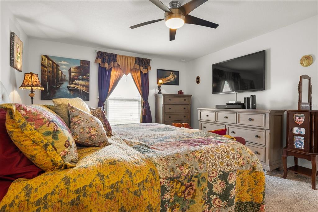 287 Inman Boulevard Winter Haven, FL 33881 - Photo 20 of 36 a bedroom with a bed and a flat screen tv