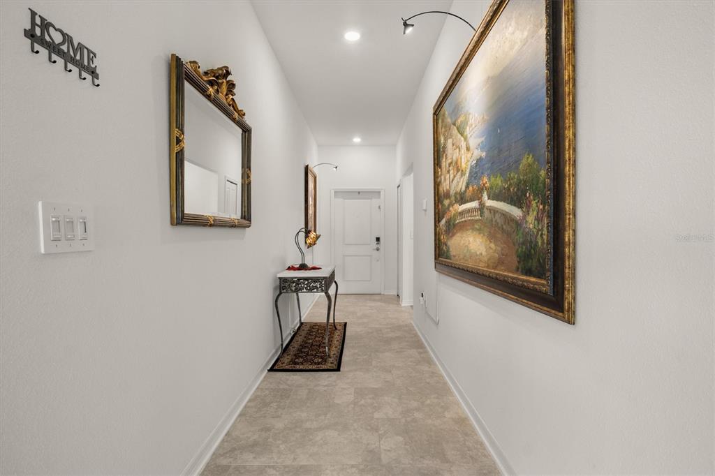 287 Inman Boulevard Winter Haven, FL 33881 - Photo 2 of 36 a view of a hallway with paintings on the wall