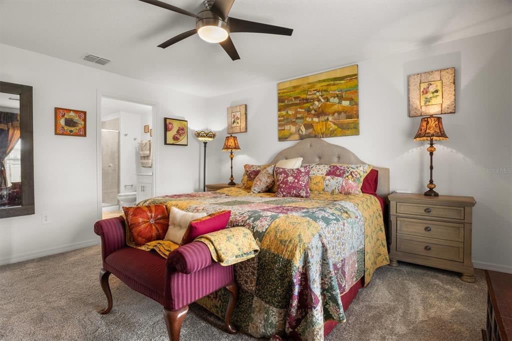 287 Inman Boulevard Winter Haven, FL 33881 - Photo 21 of 36 a bedroom with a bed and a chandelier