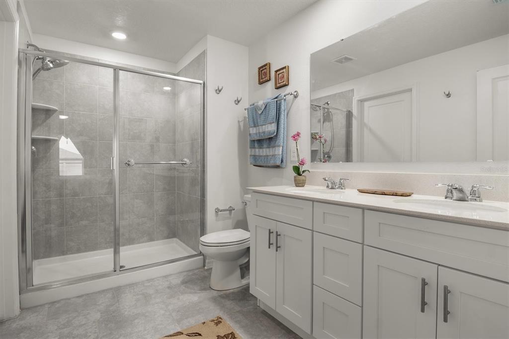 287 Inman Boulevard Winter Haven, FL 33881 - Photo 22 of 36 a spacious bathroom with a shower sink mirror and toilet