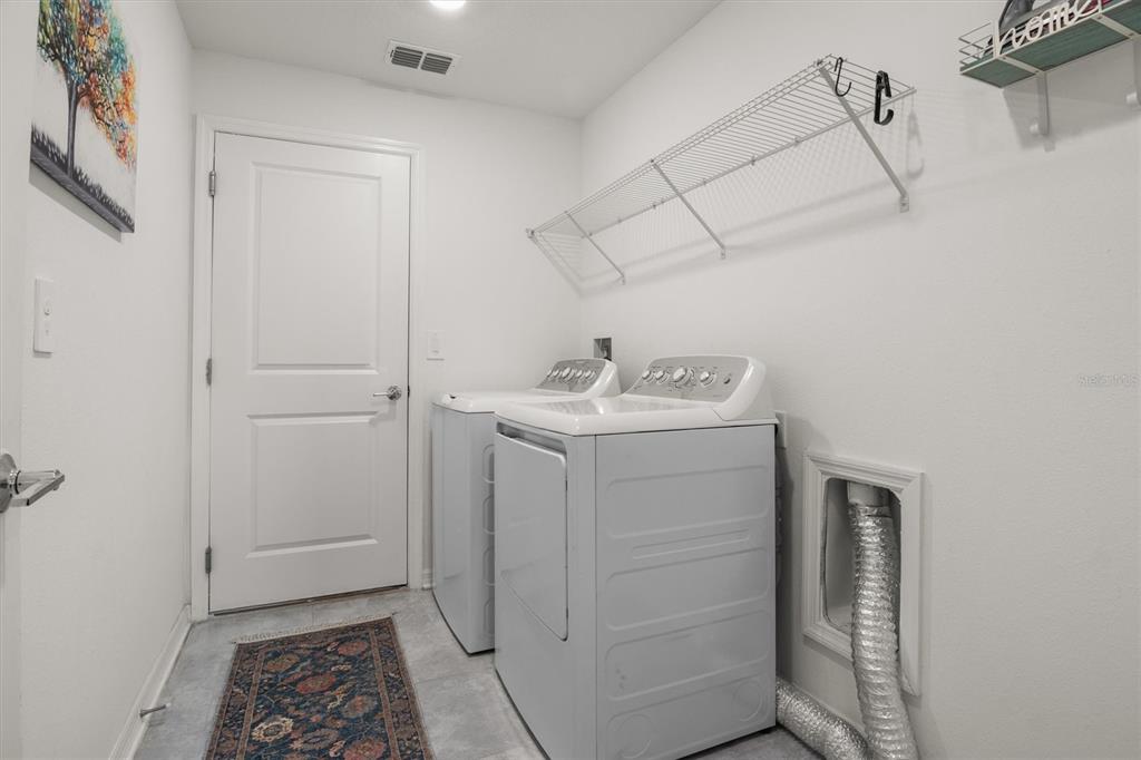 287 Inman Boulevard Winter Haven, FL 33881 - Photo 24 of 36 a utility room with cabinets washer and dryer
