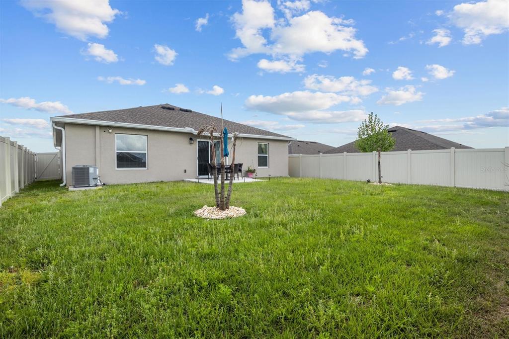 287 Inman Boulevard Winter Haven, FL 33881 - Photo 25 of 36 a front view of house with a garden and trees
